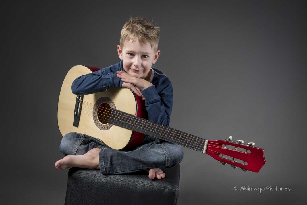 Kinderfoto vom Jungen mit Gitarre